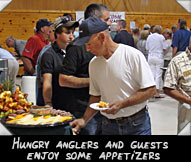 Hungry anglers and guests enjoy some appetizers while Ron & Larry Plan their strategy